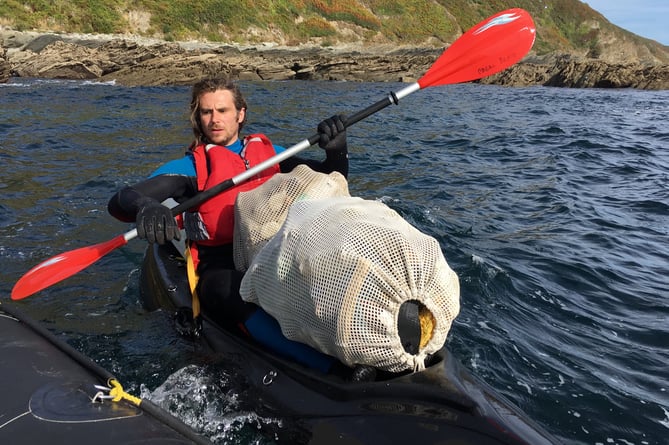 Rob Thompson in kayak with ocean plastic
