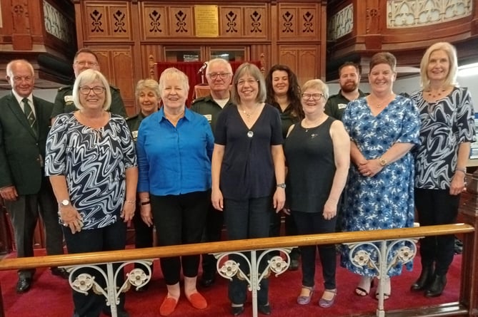 Community First Responders are seen with organiser Gareth Hopkins and musical team members of Pembroke & District Male Voice Choir and Neyland Ladies Choir after a combined fundraising concert at Tabernacle, Pembroke.