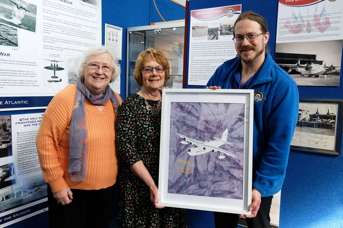 Geraldine Phillips hands over her Sunderland to David Howell, Pembroke Dock Heritage Centre’s Community Engagement Officer. With them is Councillor Pam George.
